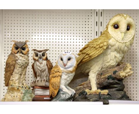 Two ceramic owls and two resin owls, largest H. 39cm.