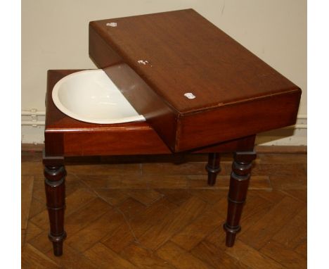 A Victorian mahogany baby's bath, with cover and kidney shape ceramic liner, on turned supports
