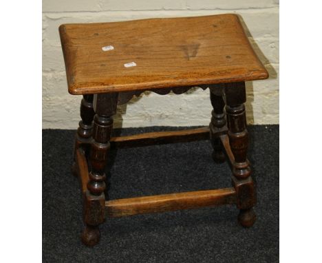 A 17th century style oak joint stool with turned and covered supports joined by stretchers. 44cm long