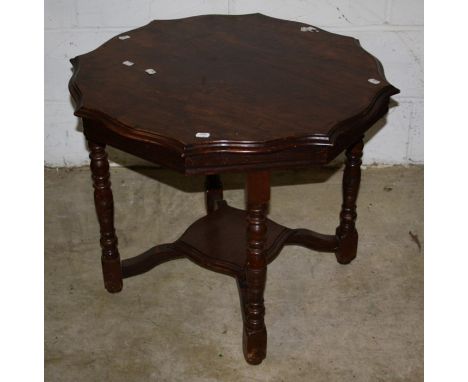 An Edwardian oak occasional table, the circular serpentine top on ring turned and block supports united by undertier, 59 x 76