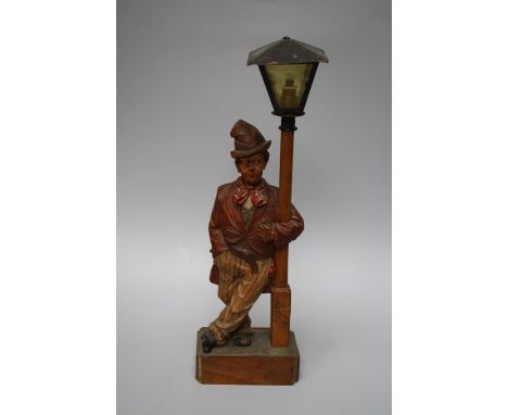 A 1930's German " Whistling Tramp" automaton table lamp, probably by Karl Griesbaum. With polychromic paint to the carved lim