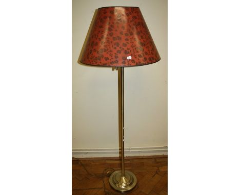 A brass standard reading lamp with adjustable arm and leopard print shade