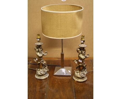 A pair of gilt cast metal figural table lamps with putti and cornucopia, 36cm high. Together with a modernist table lamp  For