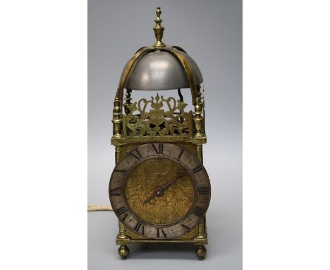 A large 17th century thirty hour brass lantern clock with high dome and bell and verge and wheel escapement. The silvered cha