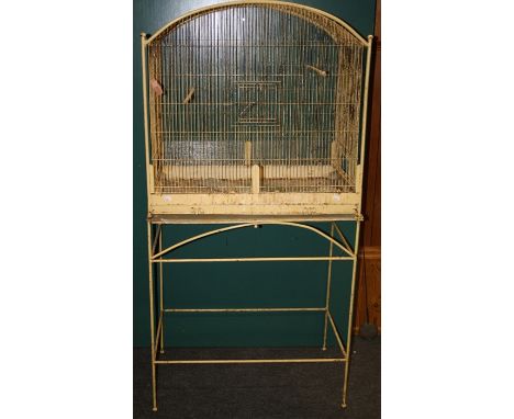 A large vintage painted parrot cage with arched top and decorative stand, 78cm wide