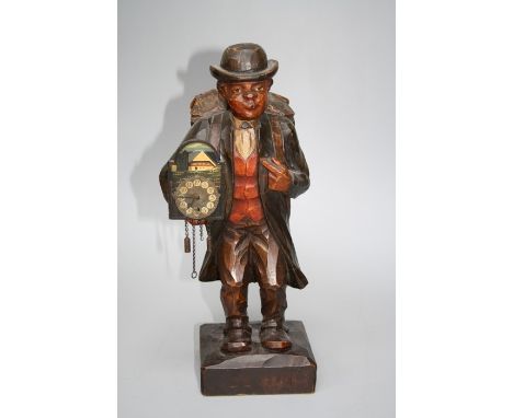 A 1920/1930's Automaton " Clock Pedlar" Black forest timepiece. The whistling figure probably by Karl Gries Baum. The limewoo