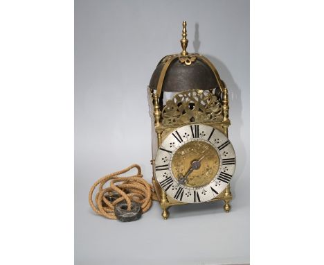 A 17th century style thirty hour lantern clock with large cast bell, silvered chapter ring and single finger. The movement wi