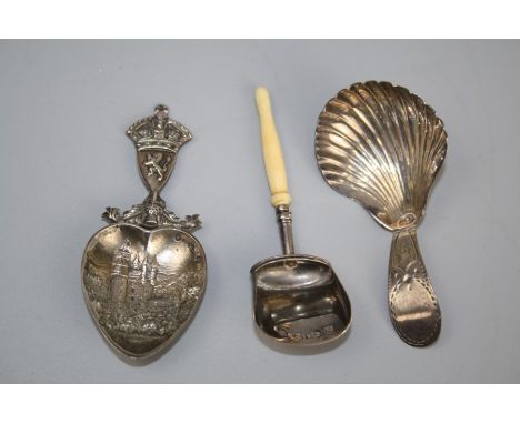 A George III silver caddy spoon with shell bowl and bright cut handle, London 1793, together with a souvenir silver love spoo