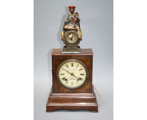 A Victorian Camerer Kuss and Co of London automaton timepiece with medieval page seated a top a cask. When the hour is reache