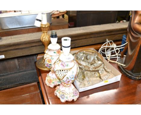 Two pendant light fittings hung with glass prism drops; a pair of continental porcelain table lamps; and a gilt wood table la