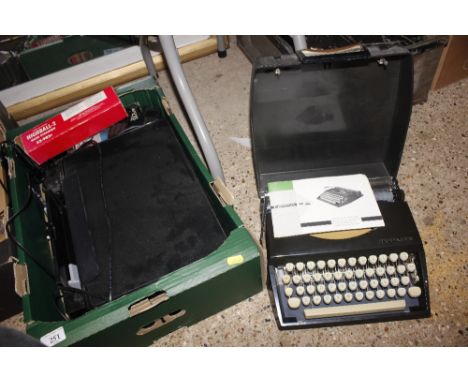 A box containing a printer, typewriter, pair of headphones etc.