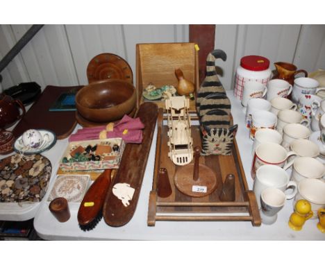 A quantity of mostly wooden ware to include a paper rack in the form of a cat, a model train, salt and pepper pots, turned wo