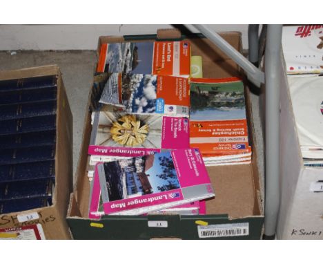 A box containing various Ordnance Survey maps