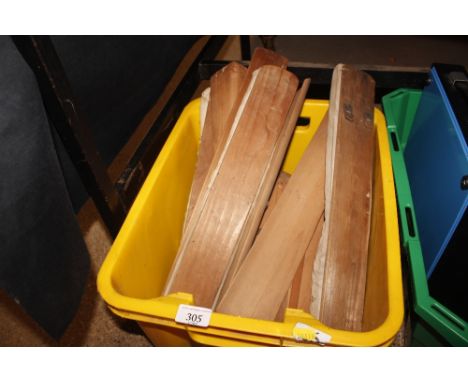 A box containing various vintage shoe horns