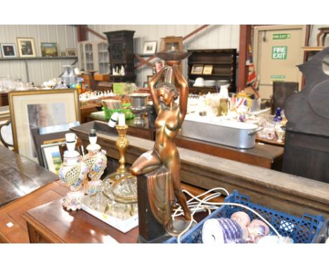 A gilt Art Deco style table lamp in the form of a naked maiden with a torch