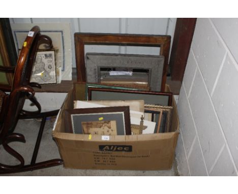 a box of various pictures, print and frames 