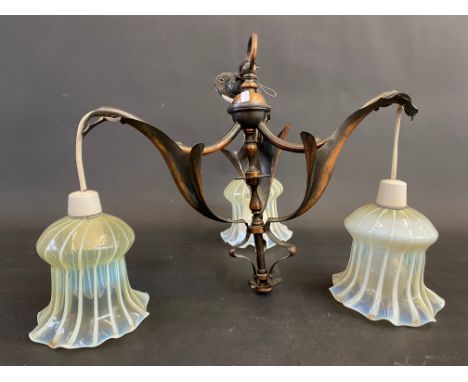 An Art Nouveau light fitting with three vaseline glass shades.