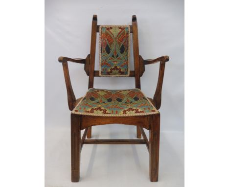 An Arts and Crafts oak framed armchair, the seat and back upholstered in Liberty print Ianthe. 