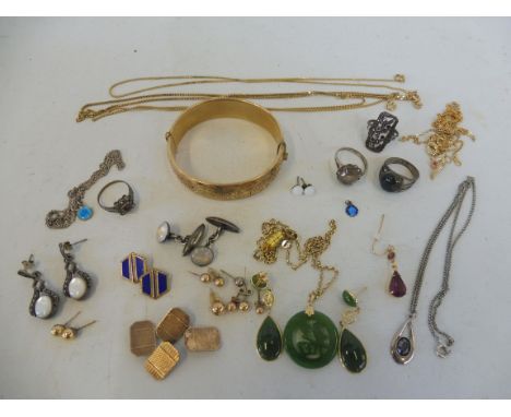 A selection of jewellery including rolled gold bangle, yellow metal chains, silver earrings, rings etc.