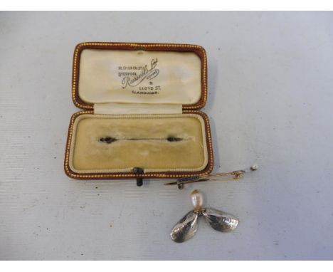 An 18k bar brooch in the form of an oyster pearl inset with six sapphires set within original retailer's case: Russells Ltd. 