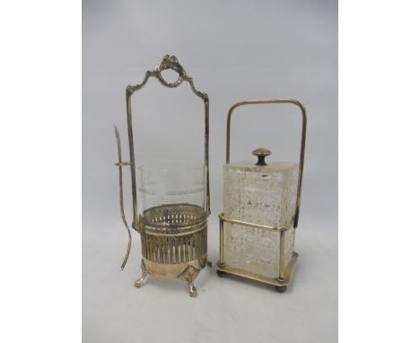 A WMF silver plated stand with glass liner and hanging pickle fork, plus a cut glass square lidded jar mounted in a WMF silve