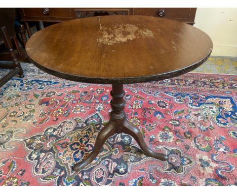 A 19th Century mahogany circular tilt top tea table raised upon a tripod base, 28" diameter. 