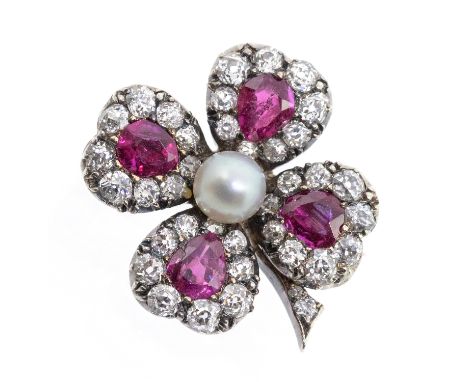 An early 20th century ruby, diamond and pearl set gold brooch in the form of a four leaf clover, each leaf set with a pear cu