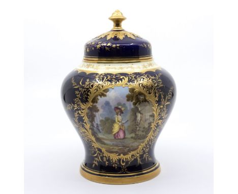 A Coalport porcelain pot pourri and cover, cobalt blue body decorated with gilt leaf and foliage raised decoration, the front