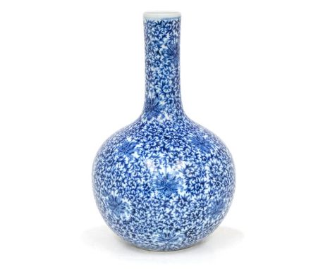 A Chinese blue and white ‘lotus’ bottle vase, tianqiuping, Qianlong seal mark, Republican period, the rounded body rising to 