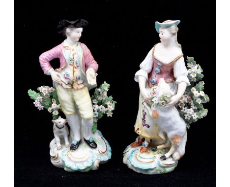 A pair of Derby patch mark figures,&nbsp;The Garland Shepherds,&nbsp;the Lady wears a bonnet, pink corset her skirt painted w