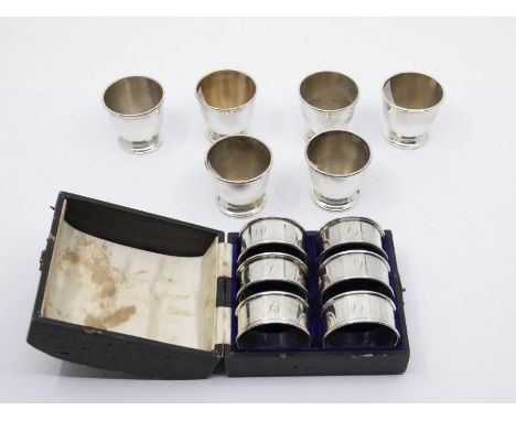 A matched set of six Art Deco silver egg cups, plain bodies, hallmarked by A C Bloxham Co., London, 1933 (1 x 1934), approx 5
