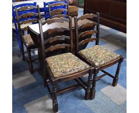 A Mid 20th Century Drop Leaf Stained Oak Oval Topped Dining Table and Four Ladder Back Chairs 