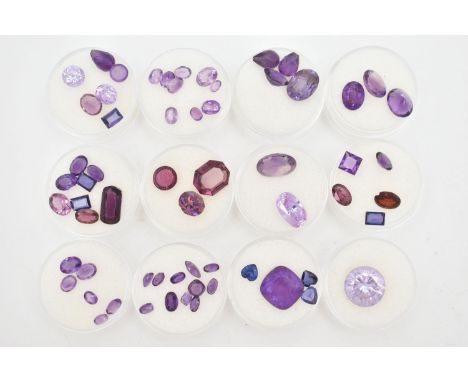 A SELECTION OF LOOSE FACETED MAINLY PURPLE GEMSTONES, to include a large circular purple cubic zirconia, a large cushion cut 