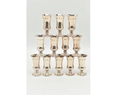 A SET OF TWELVE SILVER LIQUOR/SHERRY CUPS, tapering on round based, gilt interiors, hallmarked 'A T Cannon Ltd' Birmingham, h