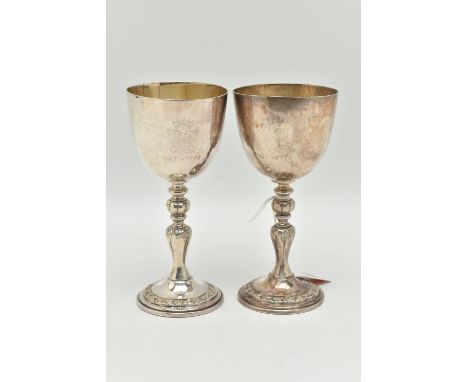 A PAIR OF ELIZABETH II SILVER COMMEMORATIVE GOBLETS, polished cups with gilt interior, engraved 'EIIR Silver Wedding 1947-197