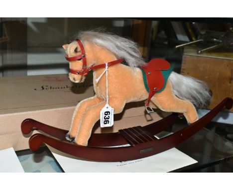 A BOXED STEIFF LIMITED EDITION ROCKING HORSE, with beige mohair covering, red leather saddle and a wooden rocker, gold colour