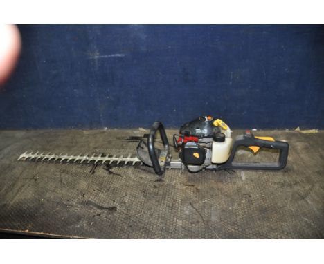 A HOMELITE HHT2660 PETROL HEDGE TRIMMER with 24in cut (engine pulls freely but hasn't started)
