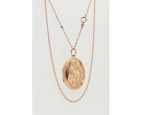 A 9CT GOLD LOCKET, an oval form locket with embossed thistle detail, hallmarked 9ct Birmingham, suspended from a fine curb li