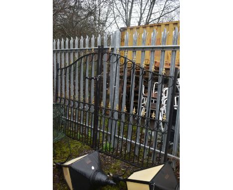 A PAIR OF WROUGHT IRON DRIVEWAY GATES, arched top, with gilt finials, overall width 454cm x each gate width 227cm x height 17