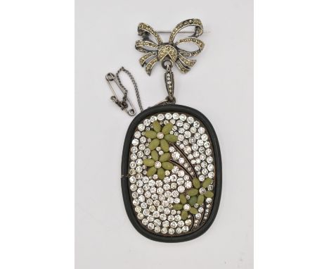 A WHITE METAL AND PASTE SET BROOCH, drop piece of a rounded rectangular form, set with colourless paste, floral detail with g