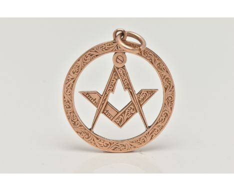 A ROSE METAL MASONIC PENDANT, of a circular open work form, depicting square and compass, with foliate pattern, approximate d