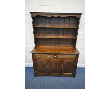 A GOOD QUALITY REPRODUCTION OAK DRESSER, the top two tier plate rack, on a base with two drawers and two cupboard doors, widt