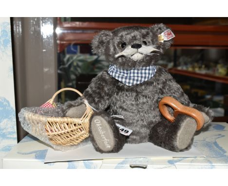 A BOXED STEIFF LIMITED EDITION OKTOBERFEST PRETZEL SELLER, No. 673924, no.354/ 1000, dark grey mohair, height 25cm, with whit