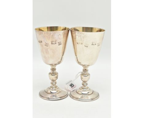 A PAIR OF ELIZABETH II SILVER GOBLETS, tapered design with engraved crest, stamped '672 1972', knopped stems on round bases, 
