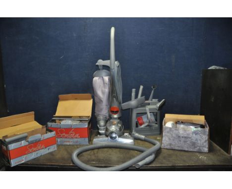 A KIRBY SENTRIA UPRIGHT VACUUM CLEANER with three boxes and a caddy containing accessories including Floor care system, Shamp