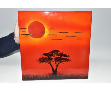 A POOLE POTTERY 'AFRICAN SKY' WALL PANEL, depicting silhouetted tree and clouds on a red/orange ground, with raised Poole Pot