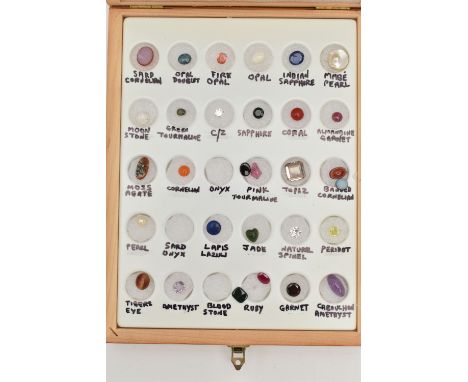 A BOXED GEMSTONE SPECIMEN SET, the thirty piece set includes sapphire, fire opal, pink tourmaline, spinel, jade etc., mainly 