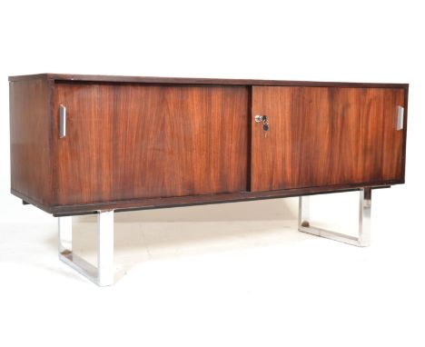 A stunning retro vintage late 20th century teak wood sideboard credenza . The sideboard having twin sliding doors revealing s