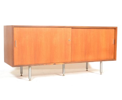 A retro vintage late 20th century teak wood sideboard credenza . The sideboard having twin sliding doors revealing separate c