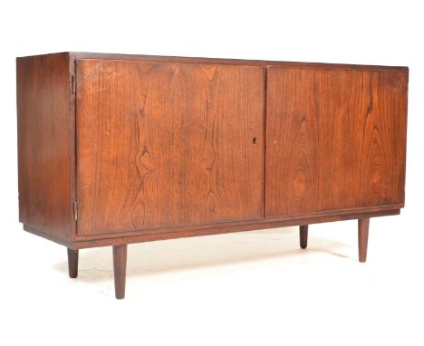 CHO - A Danish retro vintage teak wood sideboard credenza . The sideboard having double doors revealing two separate shelved 